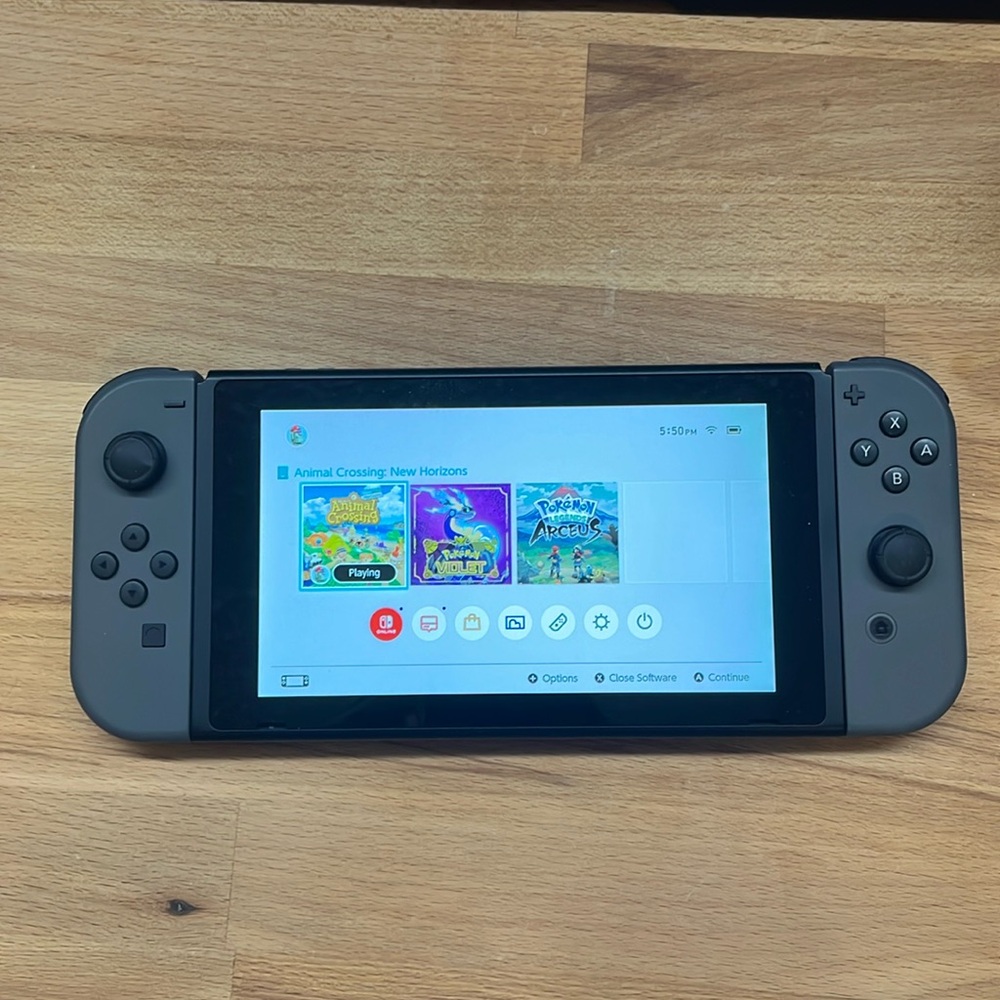 Gray Nintendo Switch With Games